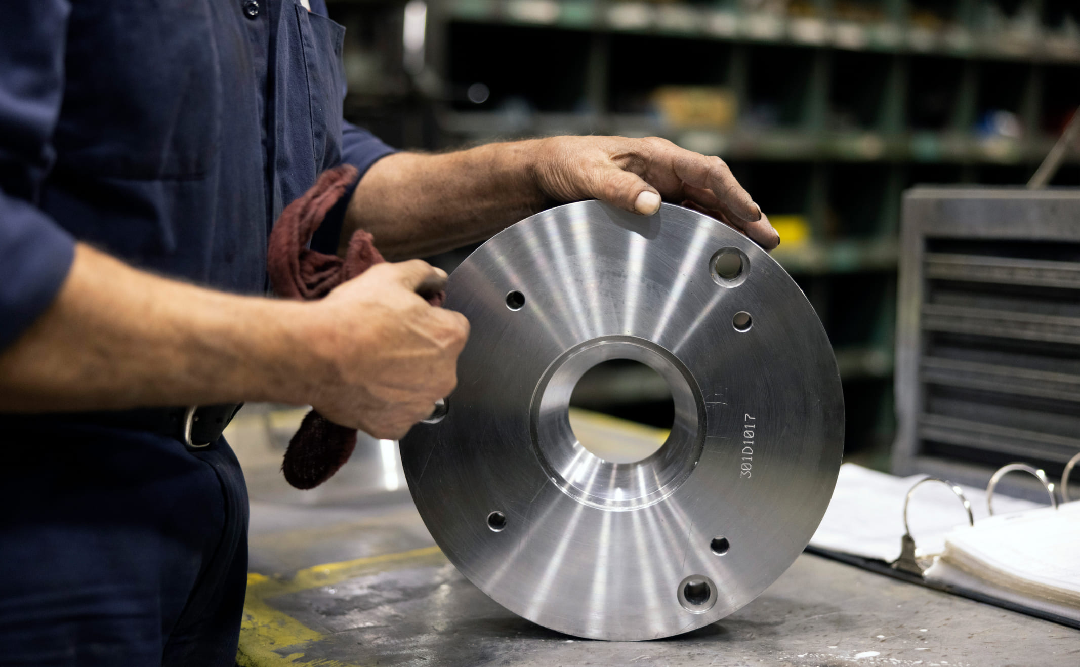 Zenar employee polishing American-made crane part